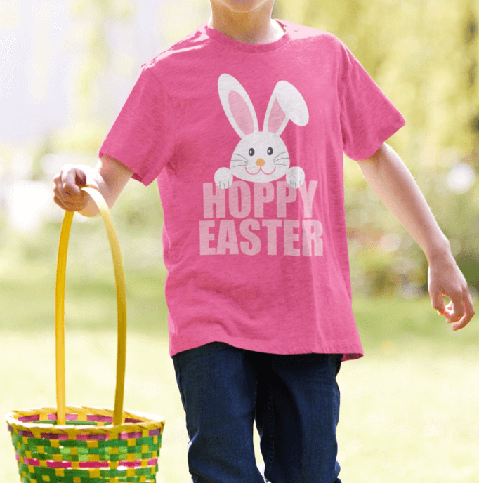 A bright pink t-shirt featuring a cute light pink bunny with big earson a bold text with Hoppy Easter