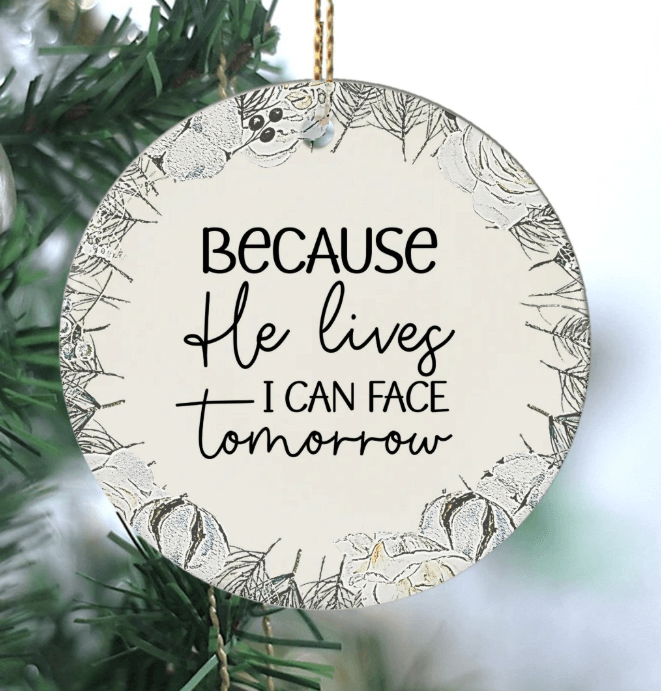 Easter Ornament featuring a floral wreath surrounding a beautiful script with the saying "Because He lives I can Face tomorrow"
