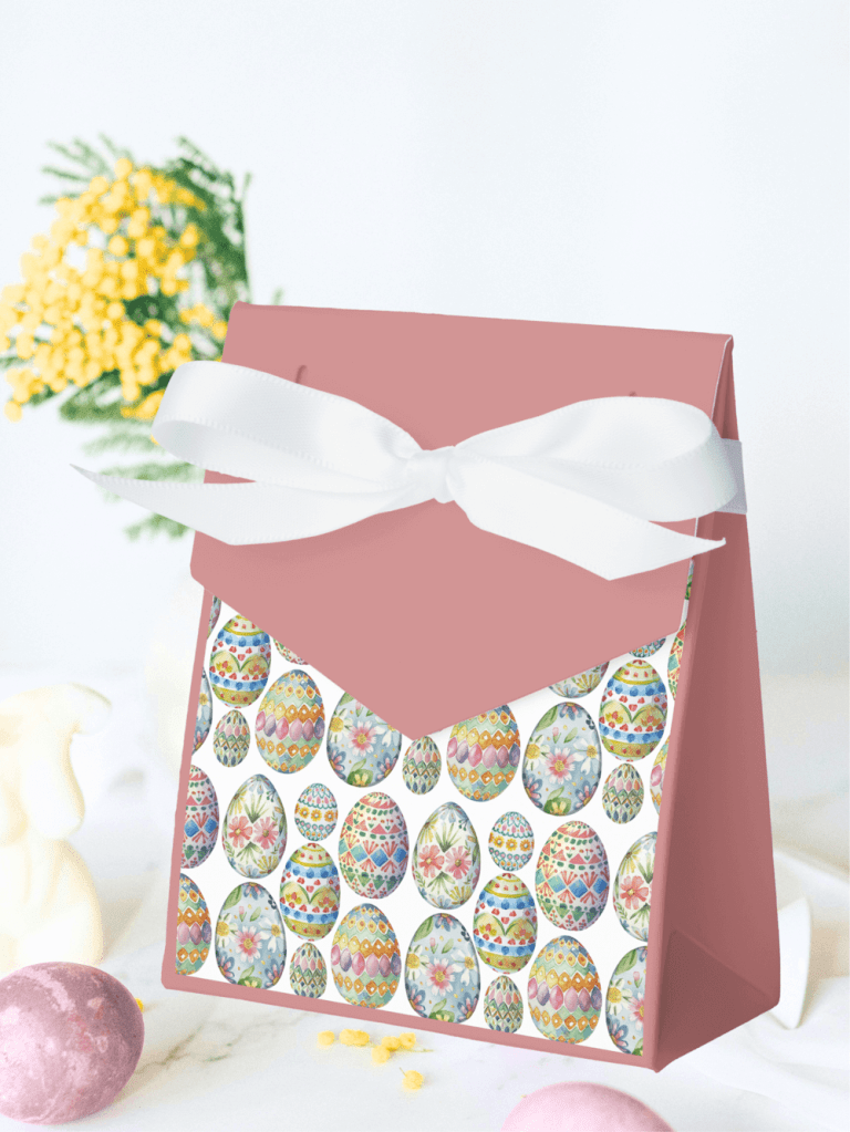 A cute Pink Easter box with a white ribbon featuring a colorful pattern of hand painted easter eggs