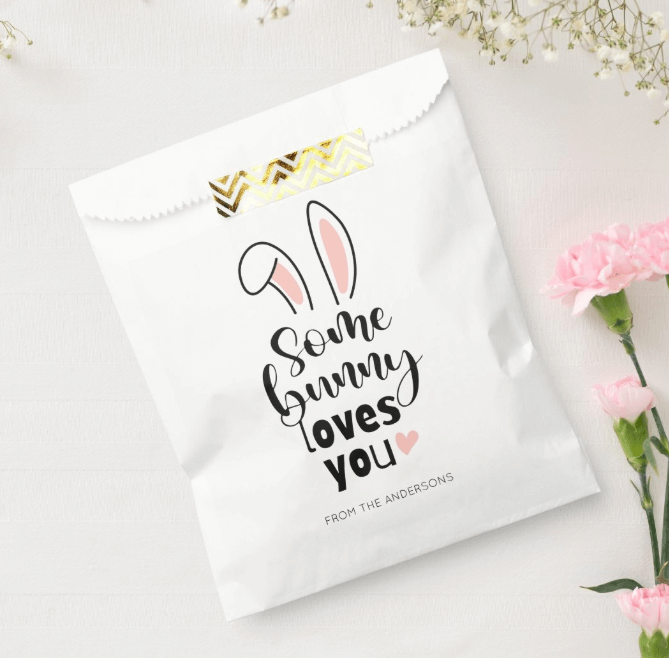 An Easter White Favor Bag featuring a trendy typography script saying Some Bunny Loves you and two cute bunny ears